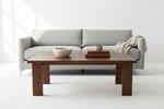 Handcrafted solid walnut wood coffee table with natural finish and tapered legs